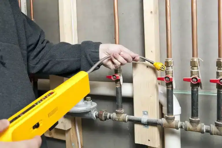 A person using a tool to connect pipes, showcasing the expertise of an HVAC Contractor North Attleboro, MA, dedicated to quality AC services and reliable installations.