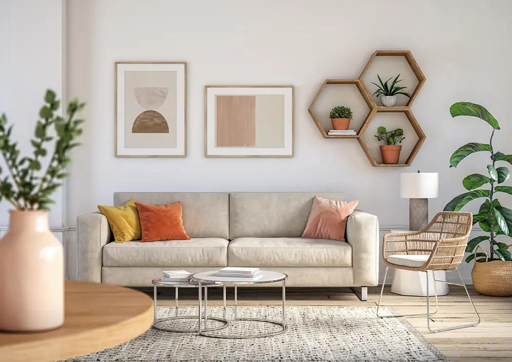 A modern living room with a beige sofa, colorful throw pillows, two round coffee tables, abstract wall art, and hexagonal shelves with plants—ideal comfort enhanced by expert AC Installation North Attleboro for year-round relaxation.