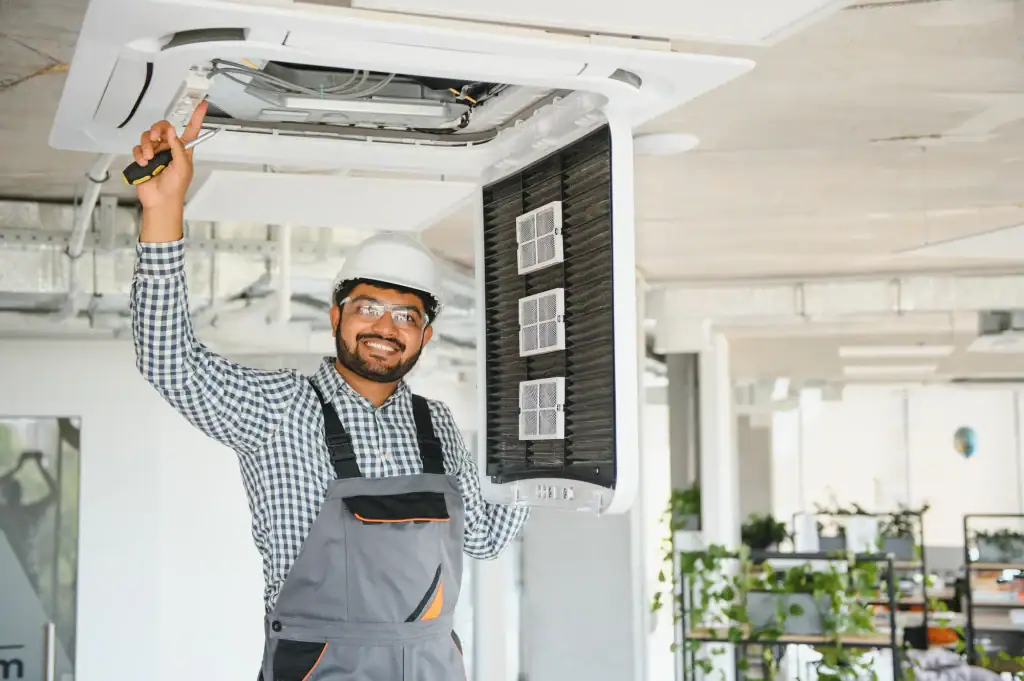 HVAC technician inspecting air conditioning unit at Dempsey Energy.